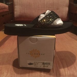 Yellow box flip flops, black glitter